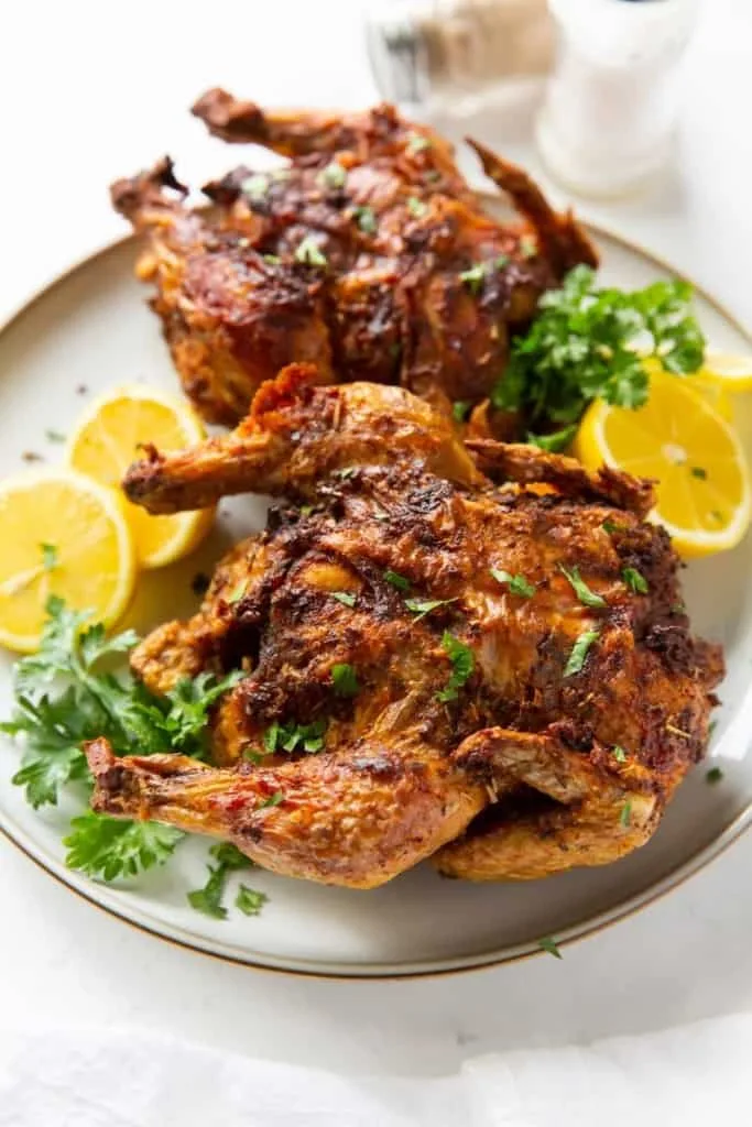 Halved cornish hen cooking