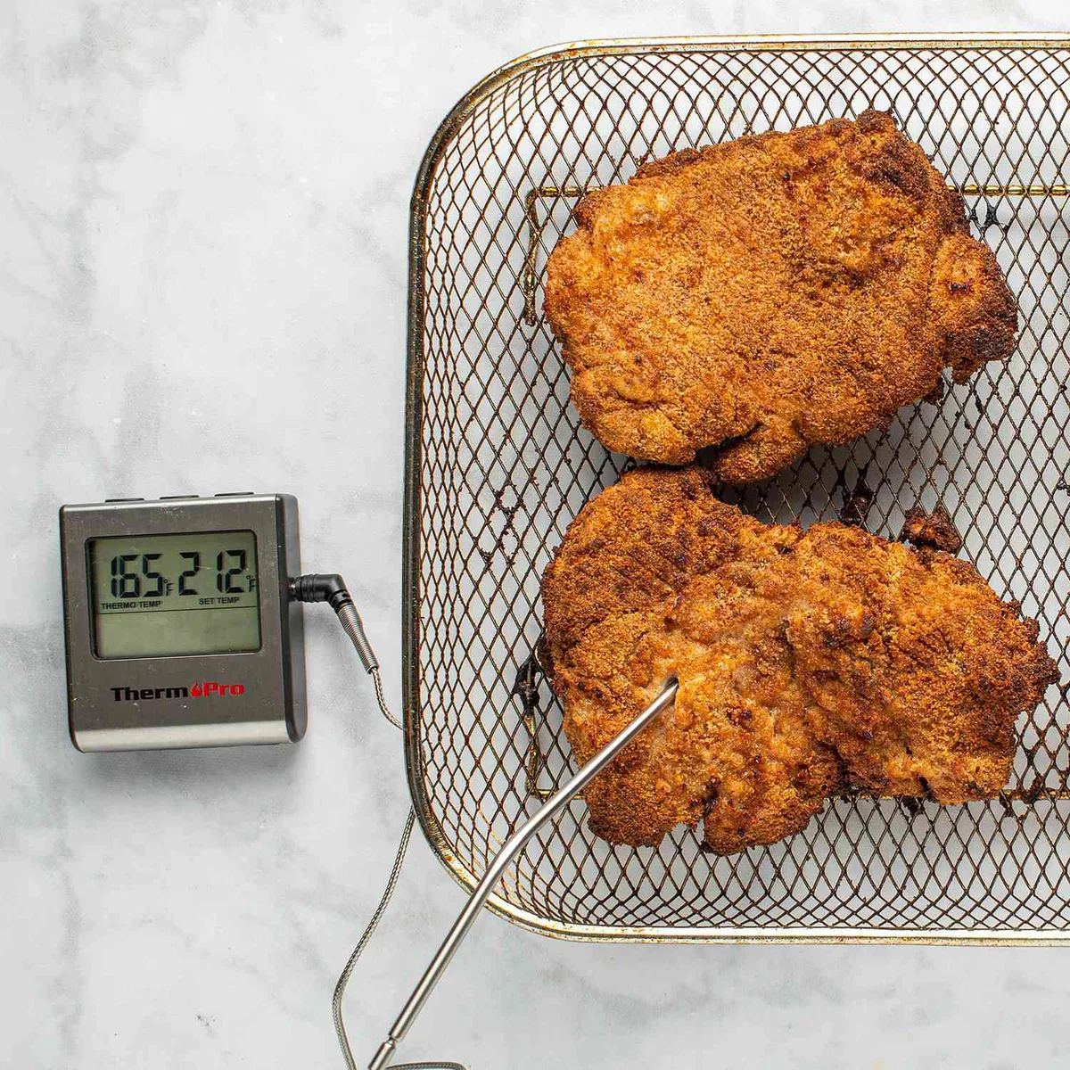 meat thermometer in chicken thigh