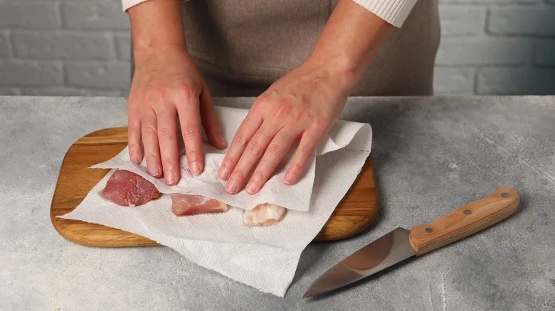patting chicken wings dry