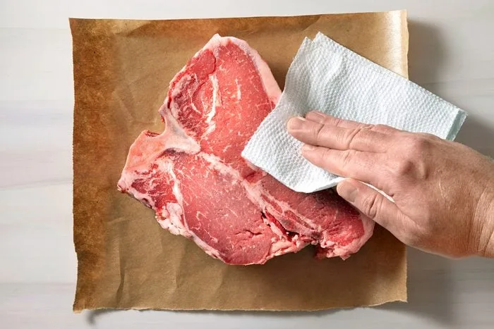 patting tuna steak dry