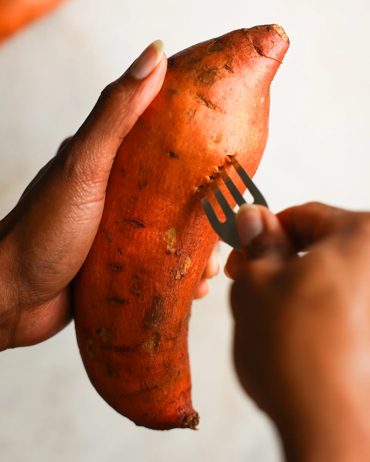 piercing sweet potato with fork