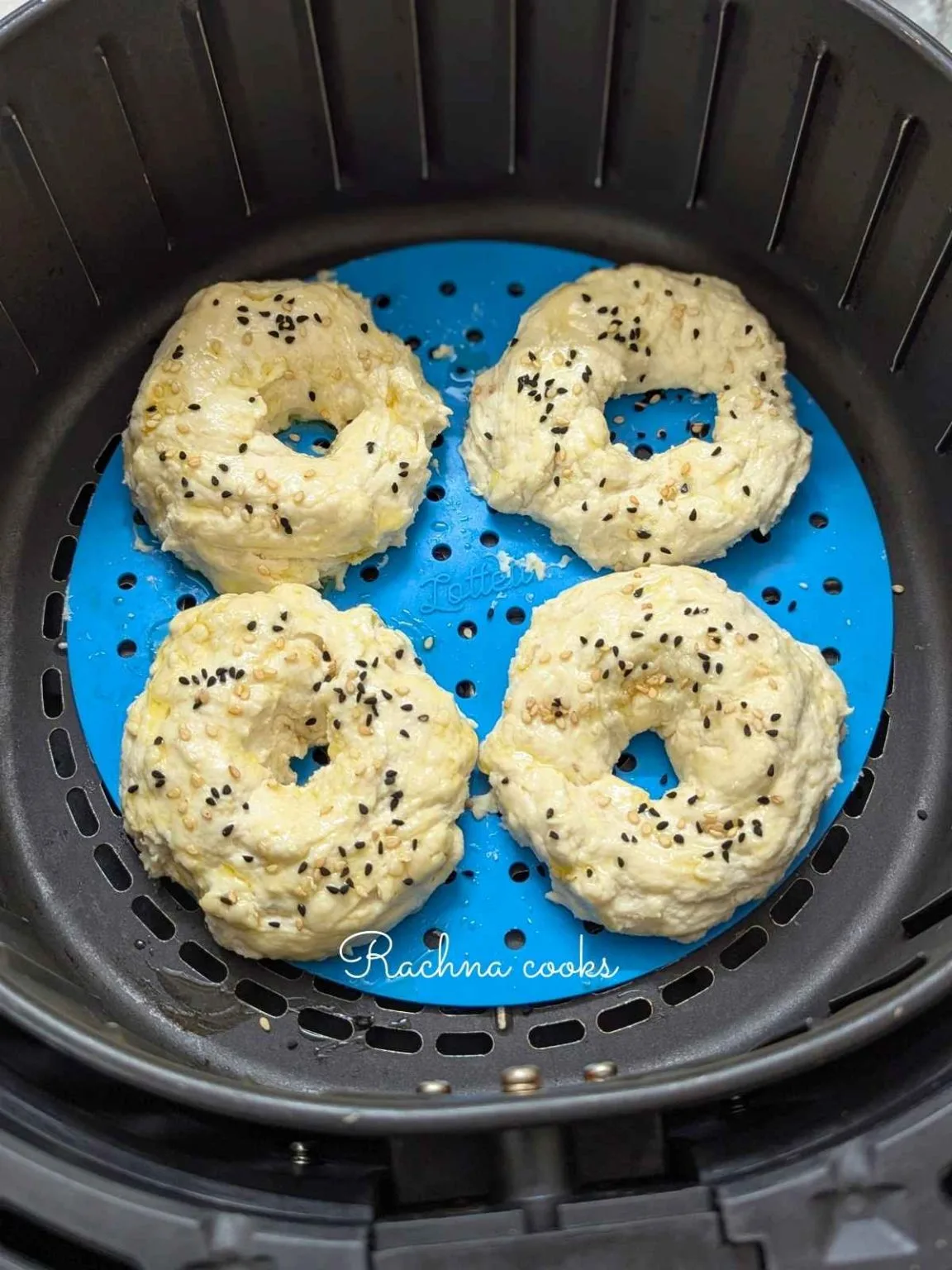 yogurt bagels in air fryer basket with parchment